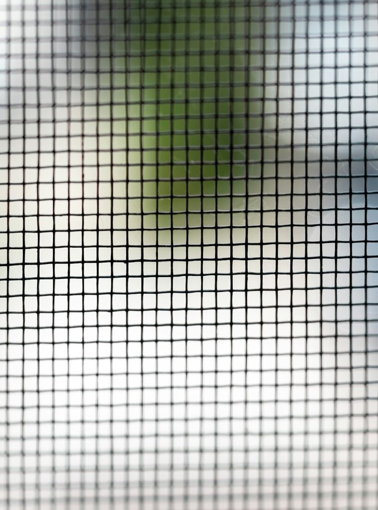 Mosquito net on the window closeup. Protection of the house from small insects